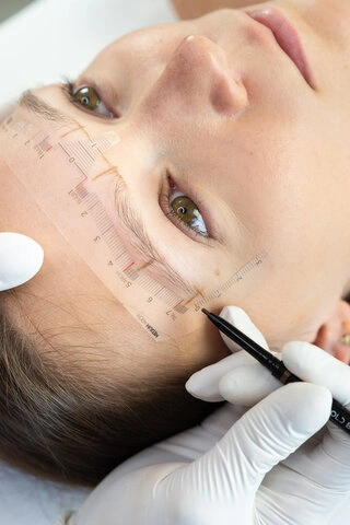 Maral measuring and mapping permanent makeup correction on a client in Richmond Hill